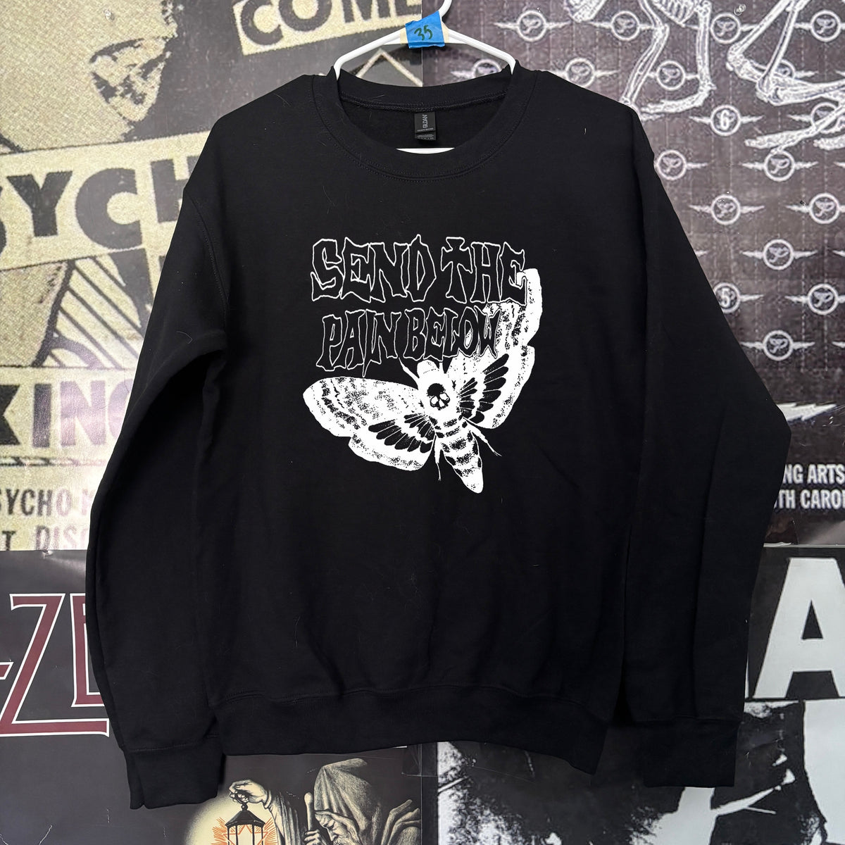PAIN BELOW black sweatshirt
