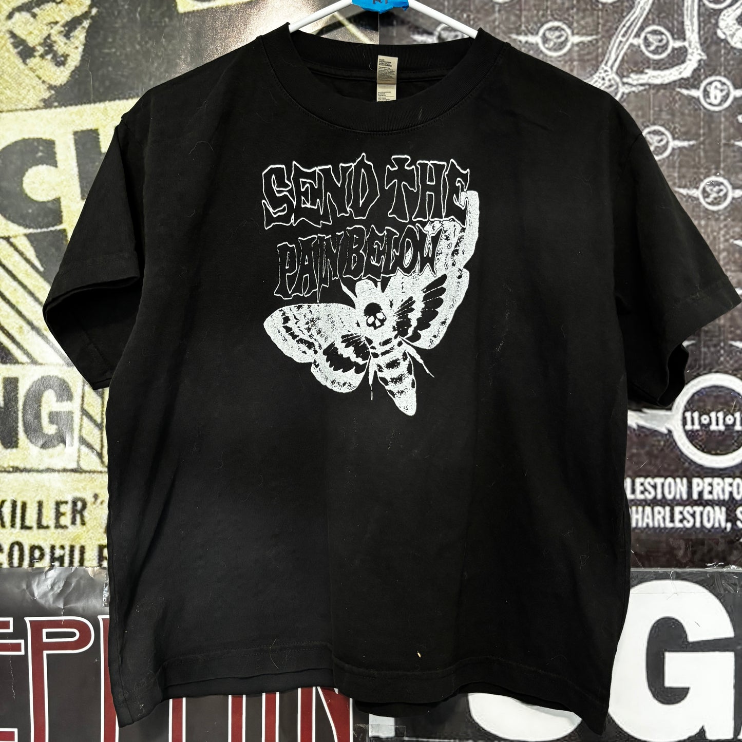Pain below boxy black tee
