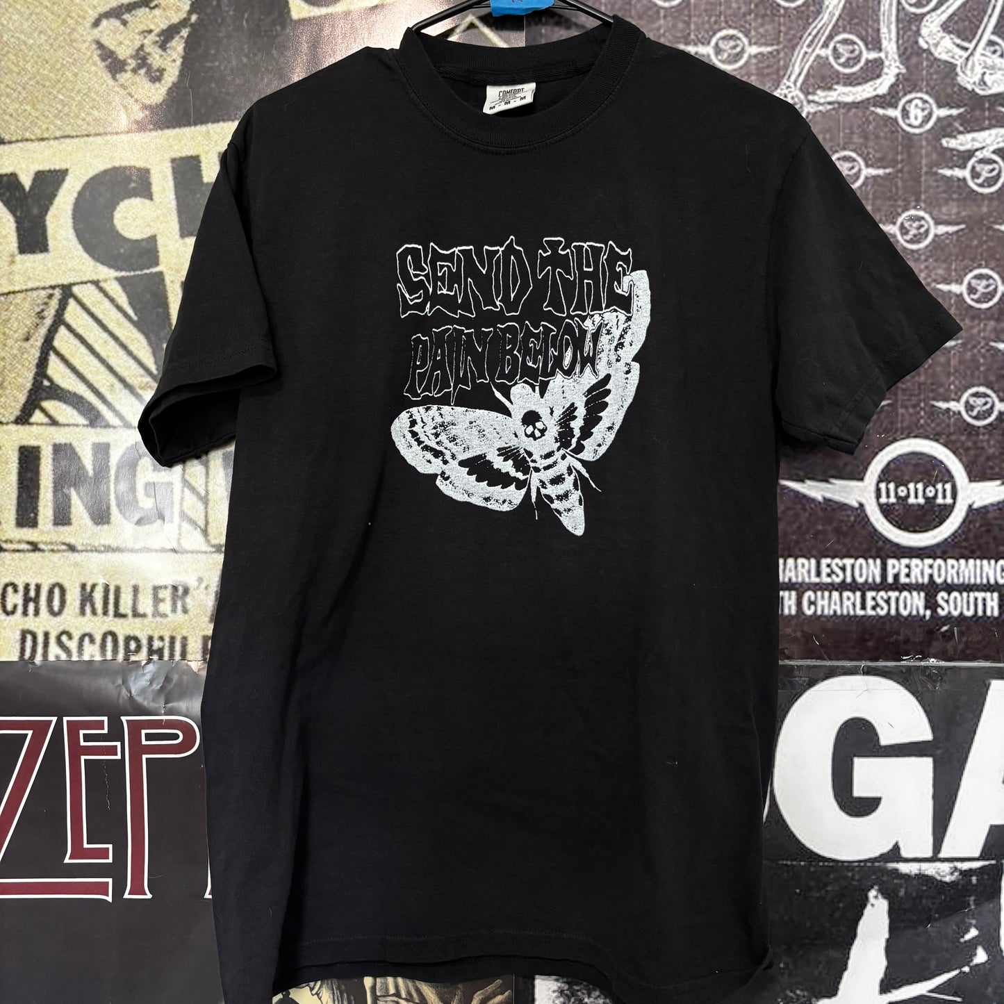 Pain below black full size tee