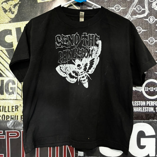 Pain below boxy black tee